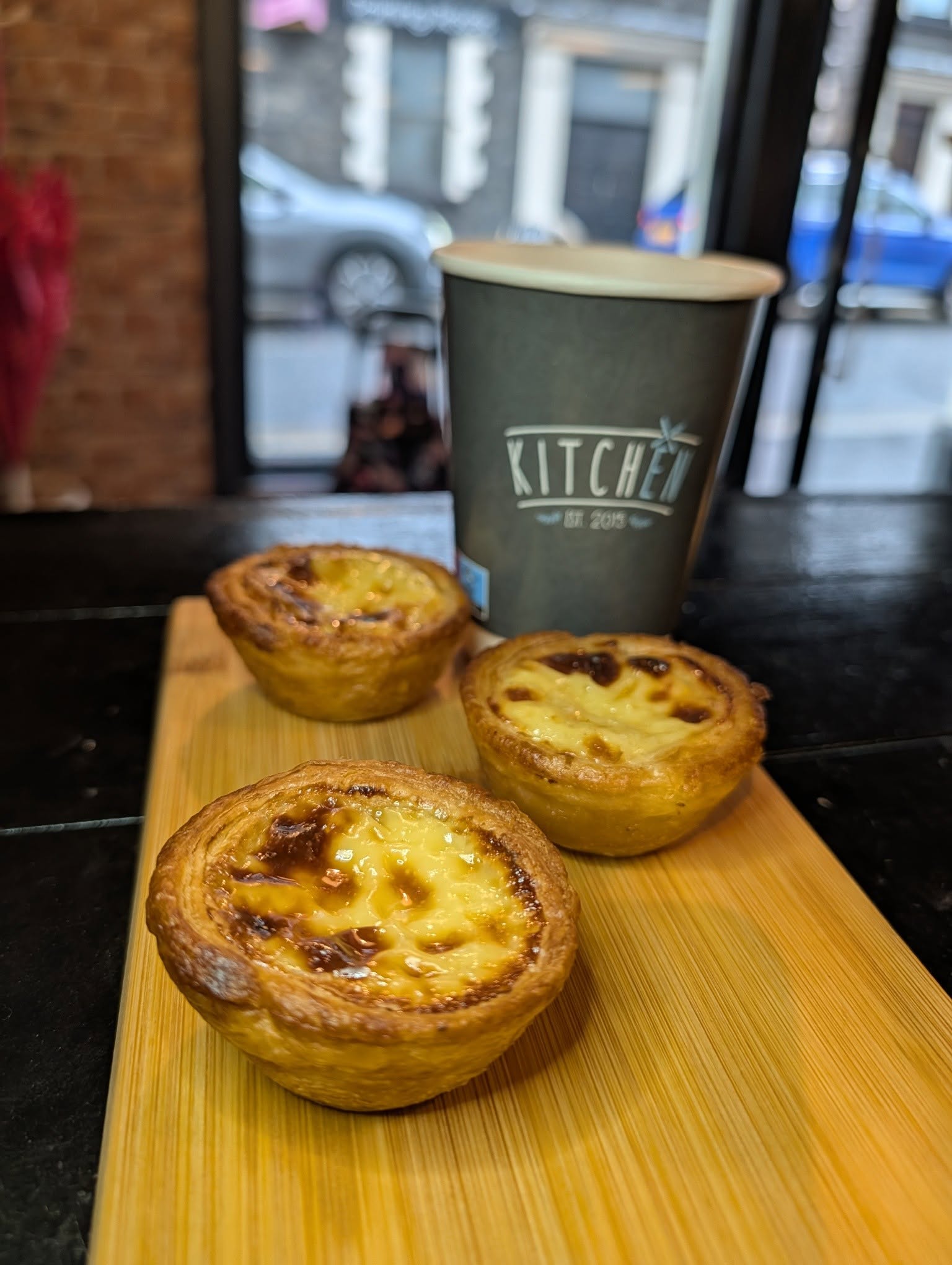 Coffee and three freshly baked custard tarts at Kitchen Lurgan
