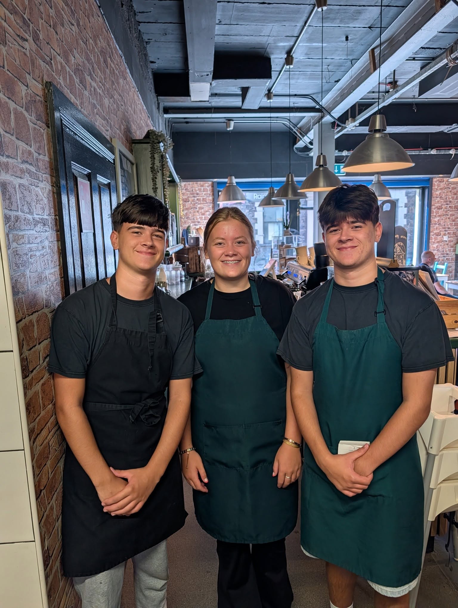 Three smiling members of the Kitchen Lurgan team